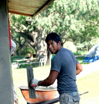 Young man handling concrete.