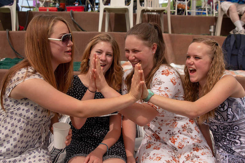 Girls high-fiving.