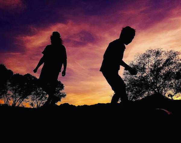 Children playing amidst the sunset.